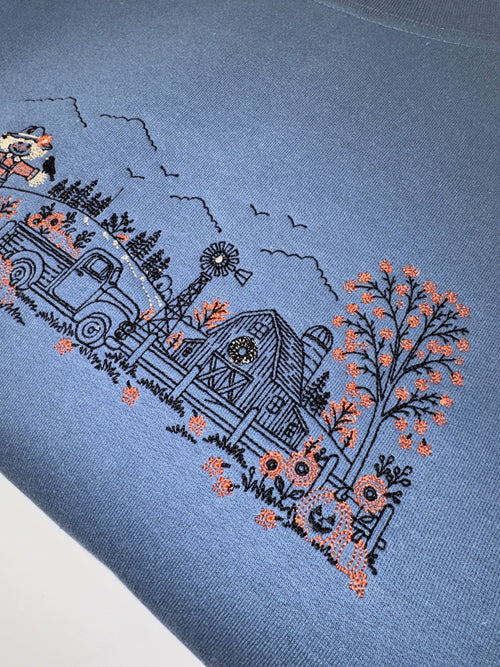 Close up of the barn, windmill and orange autumn tree on the Indigo Blue Autumn Farm crewneck