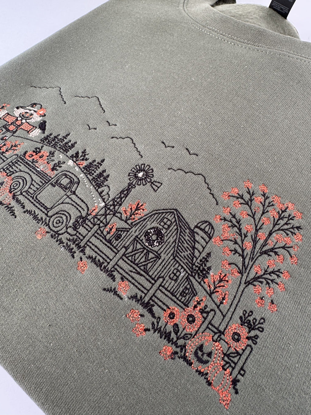 Close up of the barn, windmill and orange autumn tree on the Military Green Autumn Farm crewneck