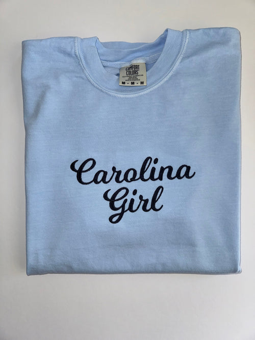 Carolina Girl embroidered in navy script on a Chambray tee
