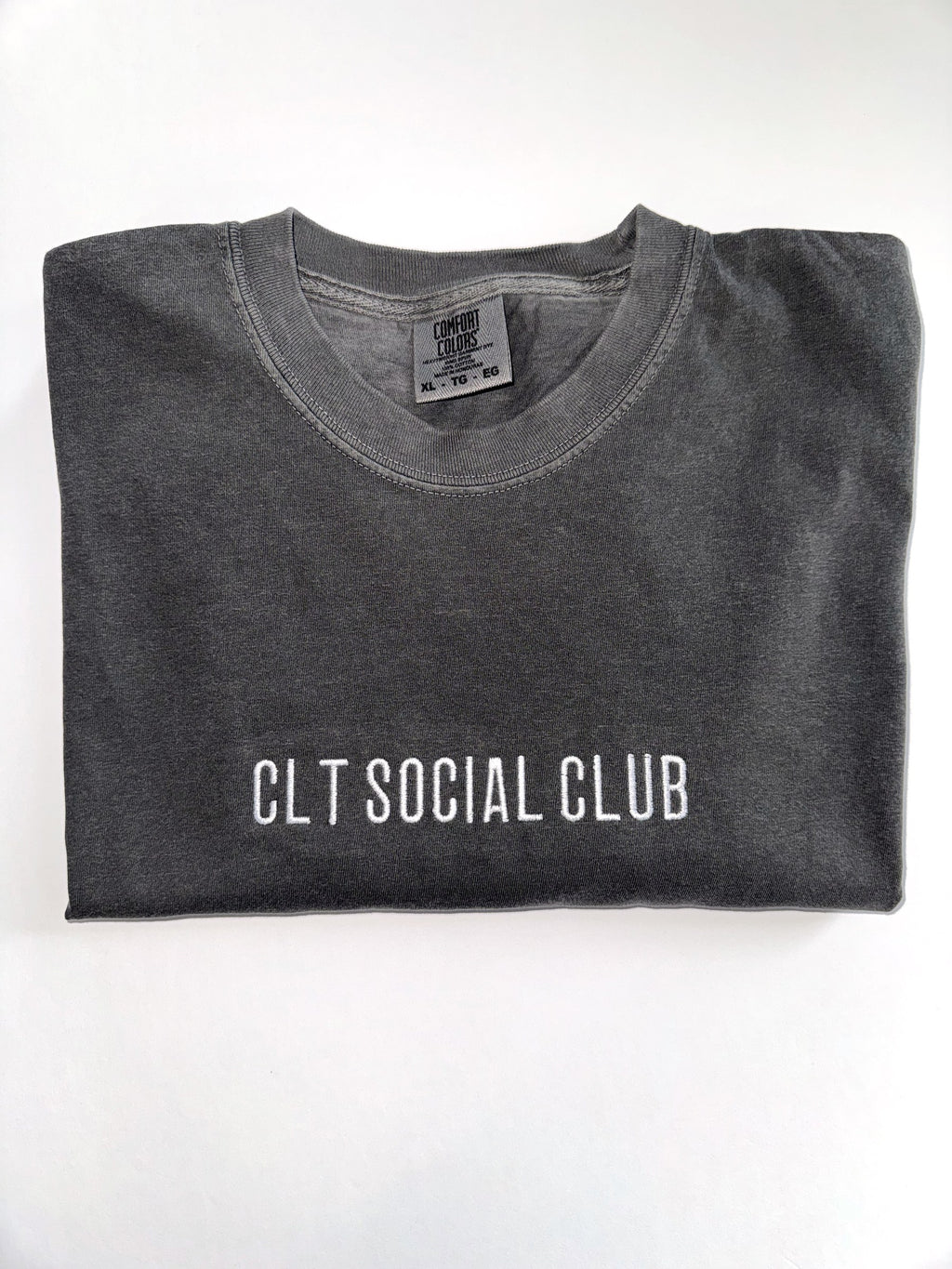 CLT Social Club embroidered tee in Pepper, folded with the collar showing