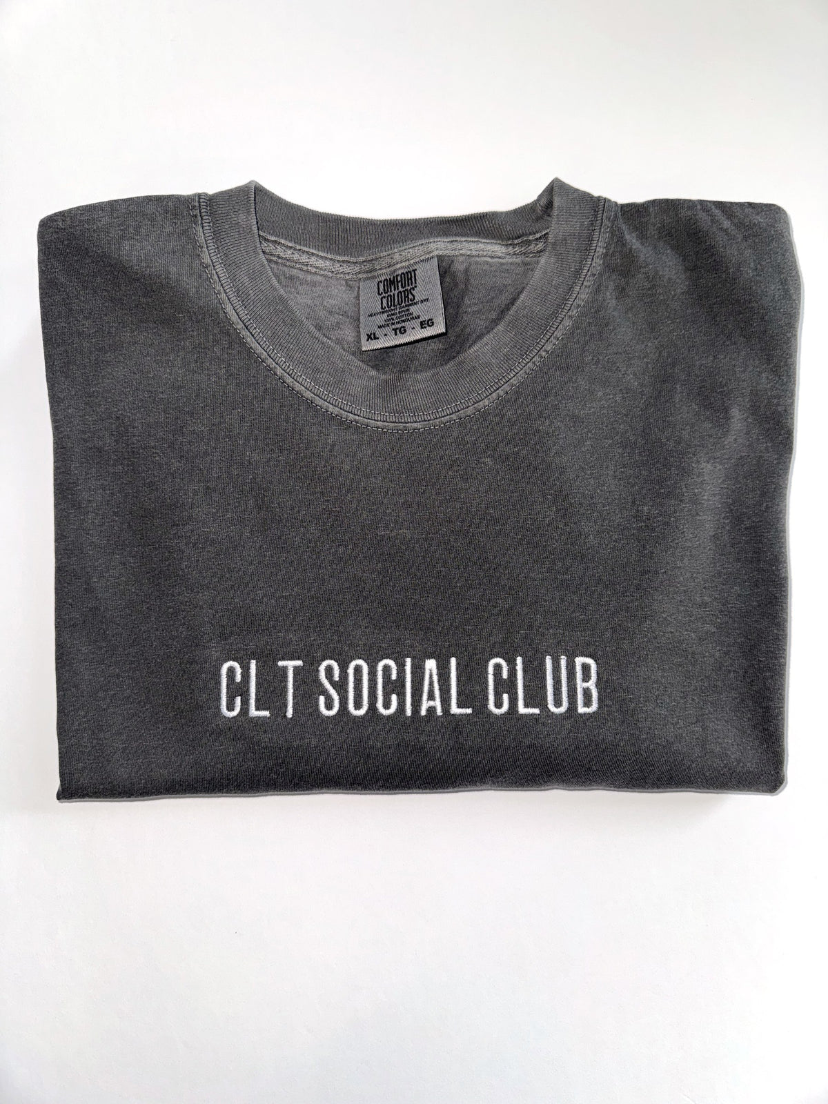 CLT Social Club embroidered tee in Pepper, folded with the collar showing