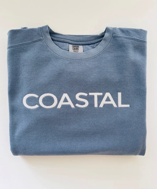 Coastal embroidered crewneck in Blue Jean, folded with the collar showing