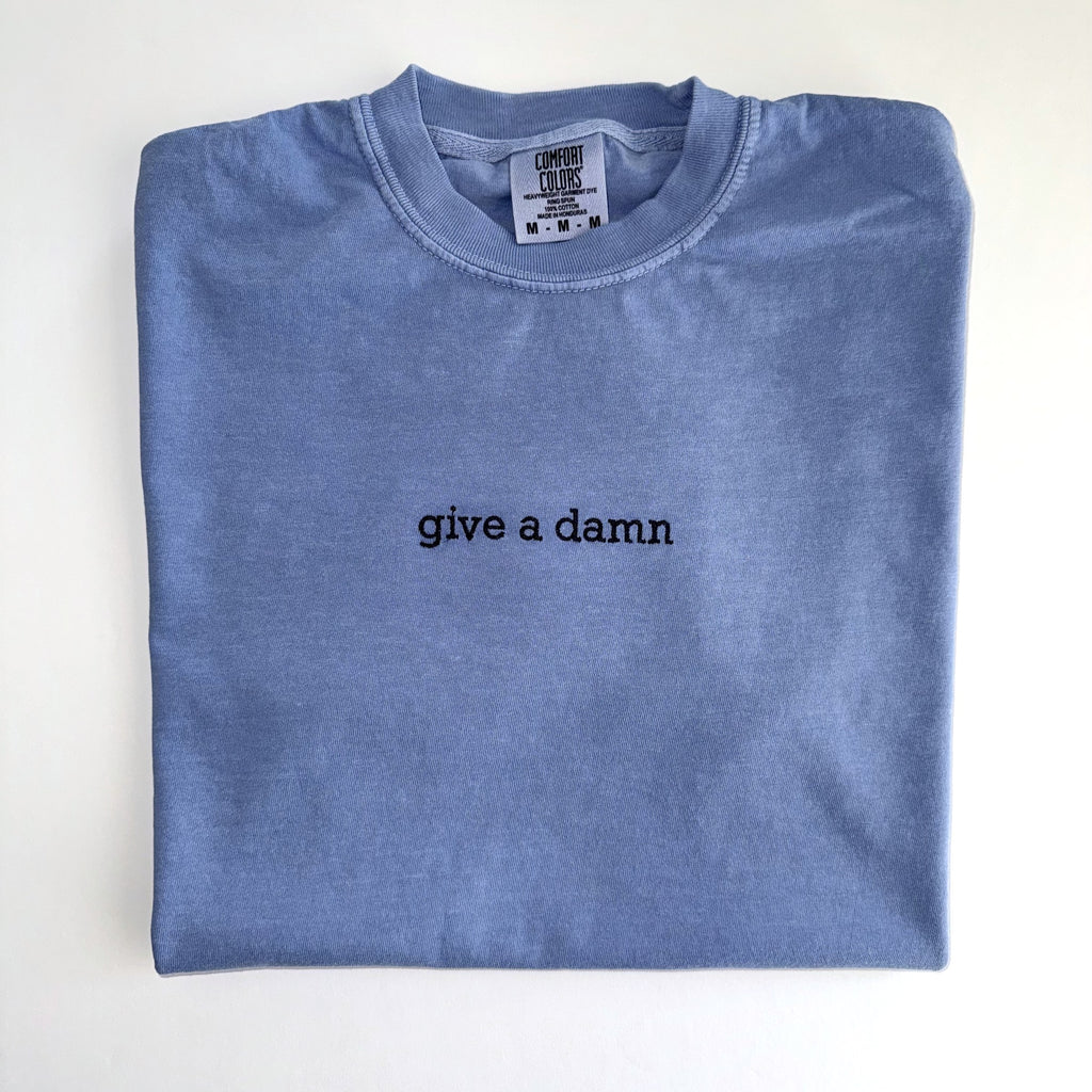 Give a damn embroidered in black thread on a Washed Denim tee