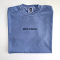 Give a damn embroidered in black thread on a Washed Denim tee