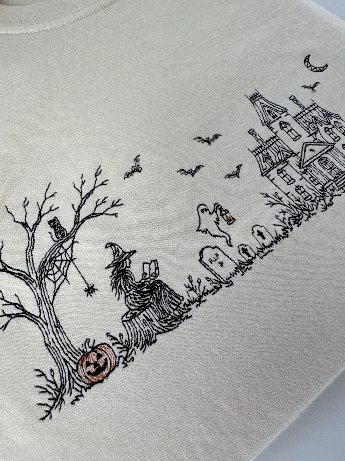 Close up of the haunted manor, bats, crescent moon and carved pumpkins in the Haunted Manor embroidery