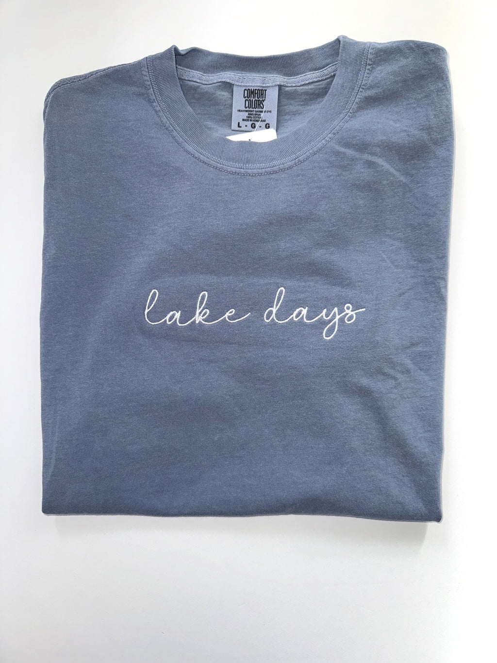 Lake Days embroidered tee in Blue Jean with white cursive script across the chest