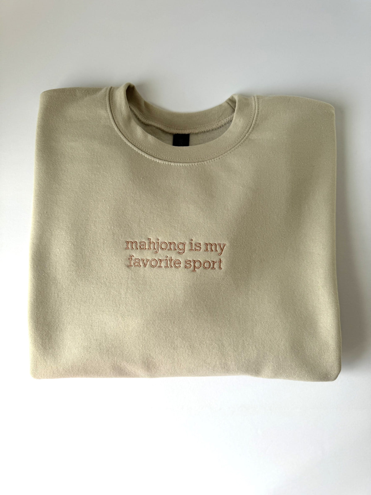 Mahjong Is My Favorite Sport embroidered on a Sand crewneck in rose tan thread