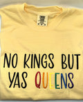 "No kings but yas queens" embroidered tee in Butter, folded flat with the collar showing