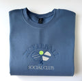 Pickleball Social Club embroidered crewneck in Indigo Blue, folded with the collar showing