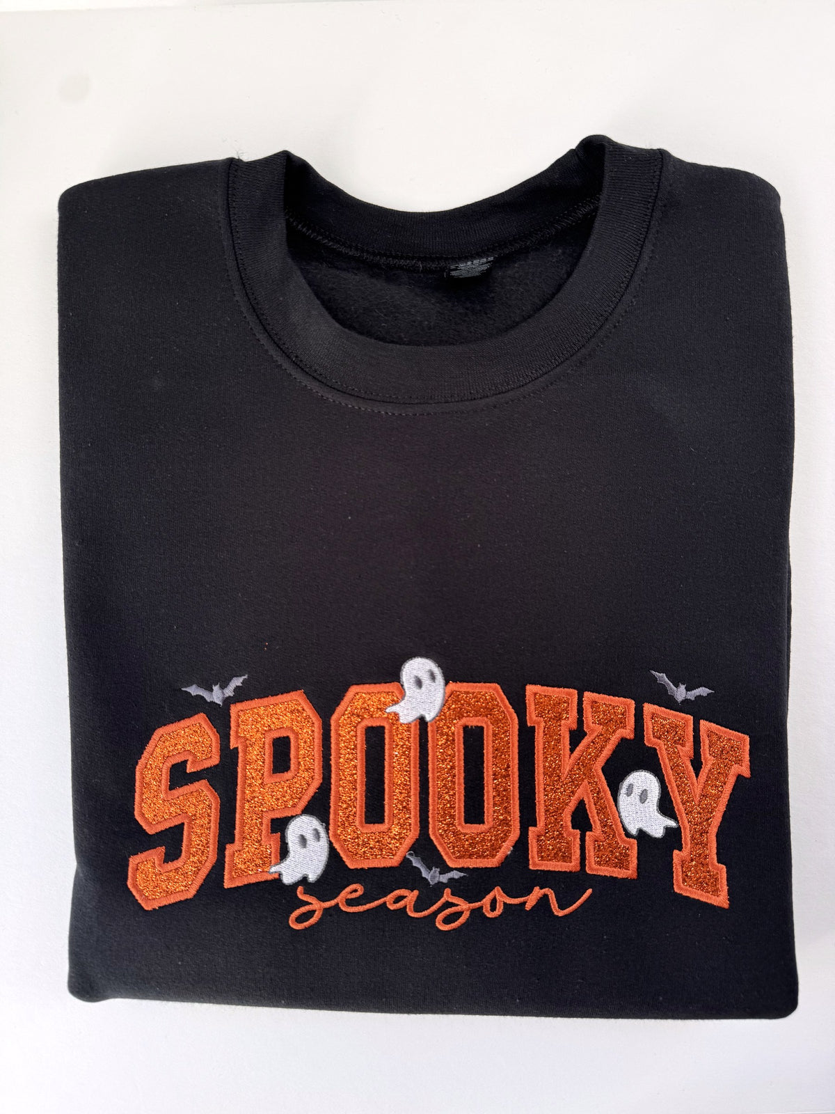 Spooky Season glitter appliqué crewneck in Black with orange glitter letters, orange script, ghosts and bats
